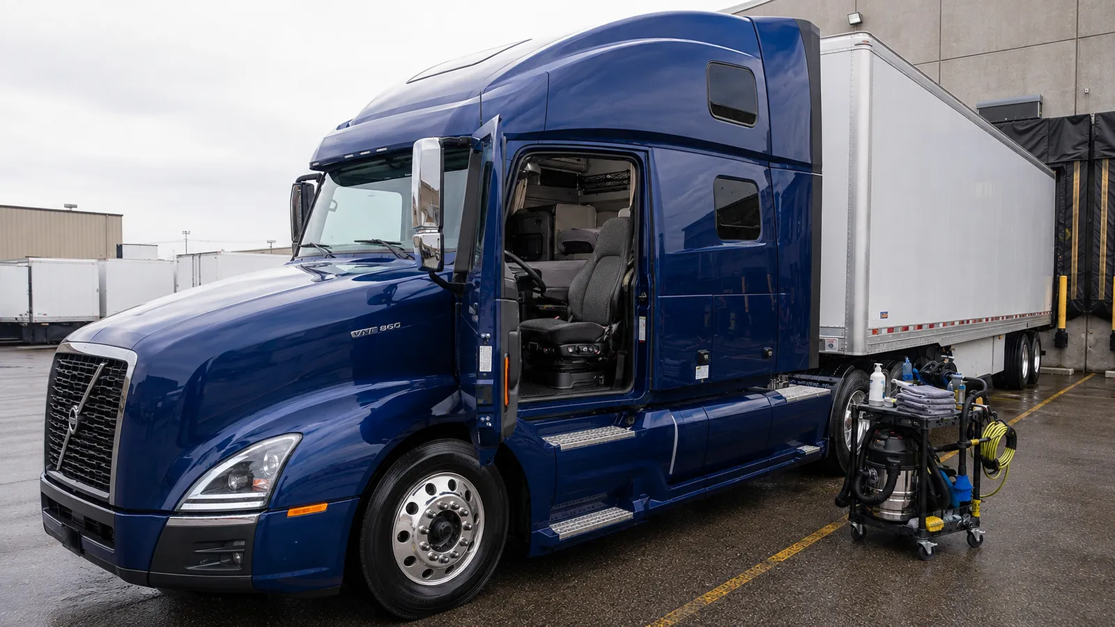 The front of a blue tractor unit during a mobile truck detail