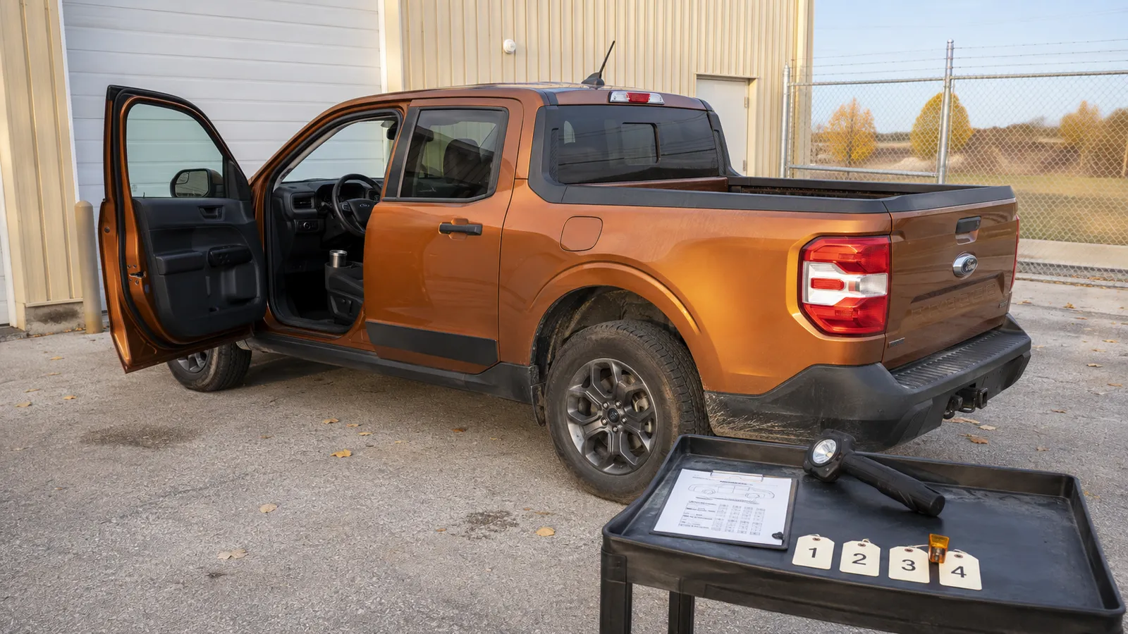 The open tailgate of an orange pickup truck after a detail